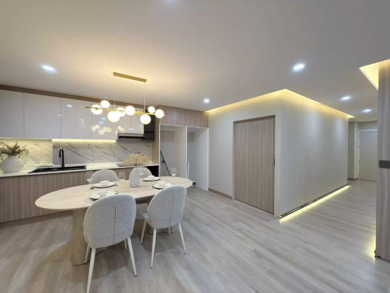 Modern dining area with oval marble table and grey chairs in 2-bed condo for sale at The Winning Tower