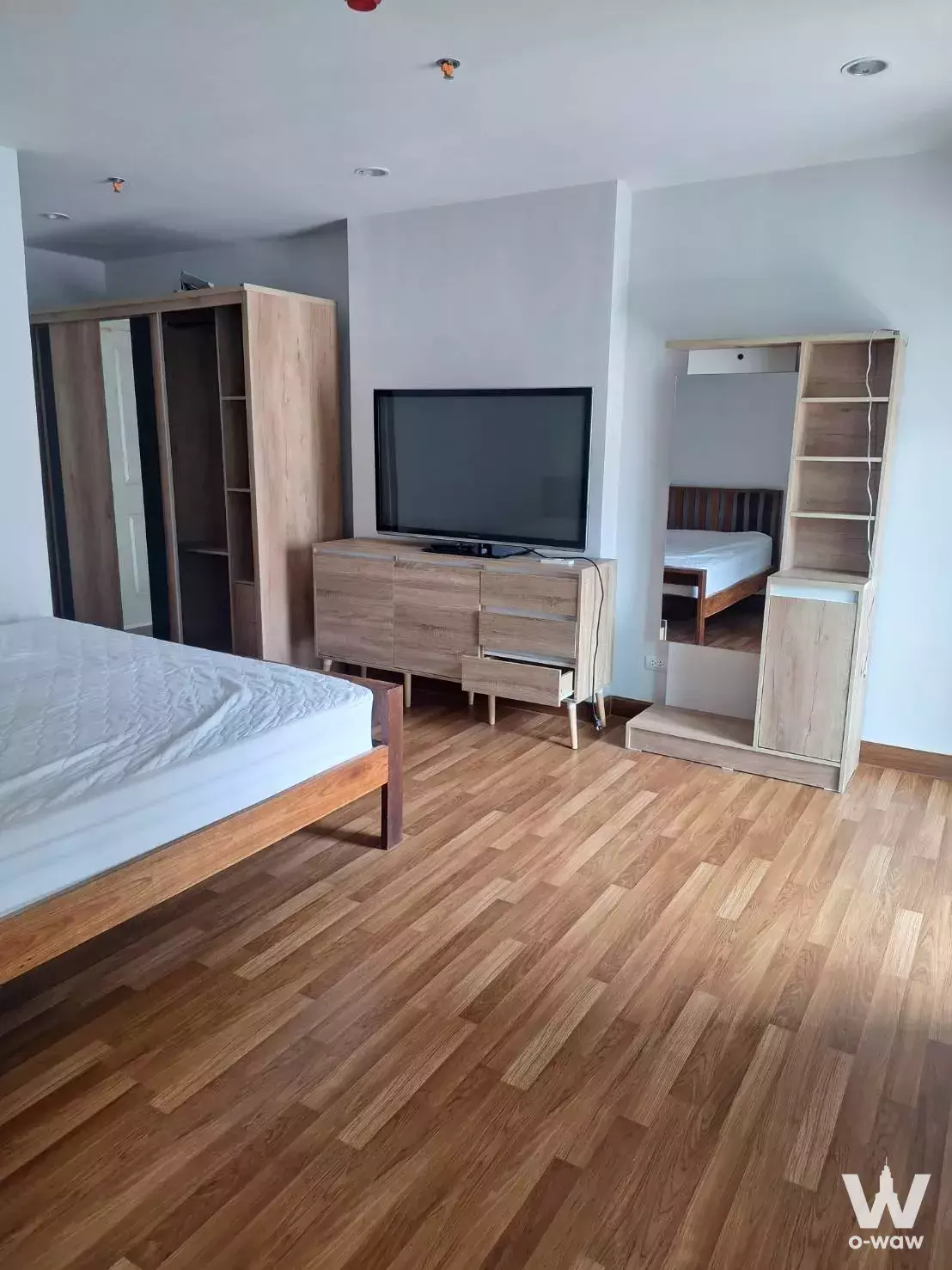 Minimalist bedroom with light wood flooring, queen bed, and floor-to-ceiling wardrobe in Regent Home Bangson 27