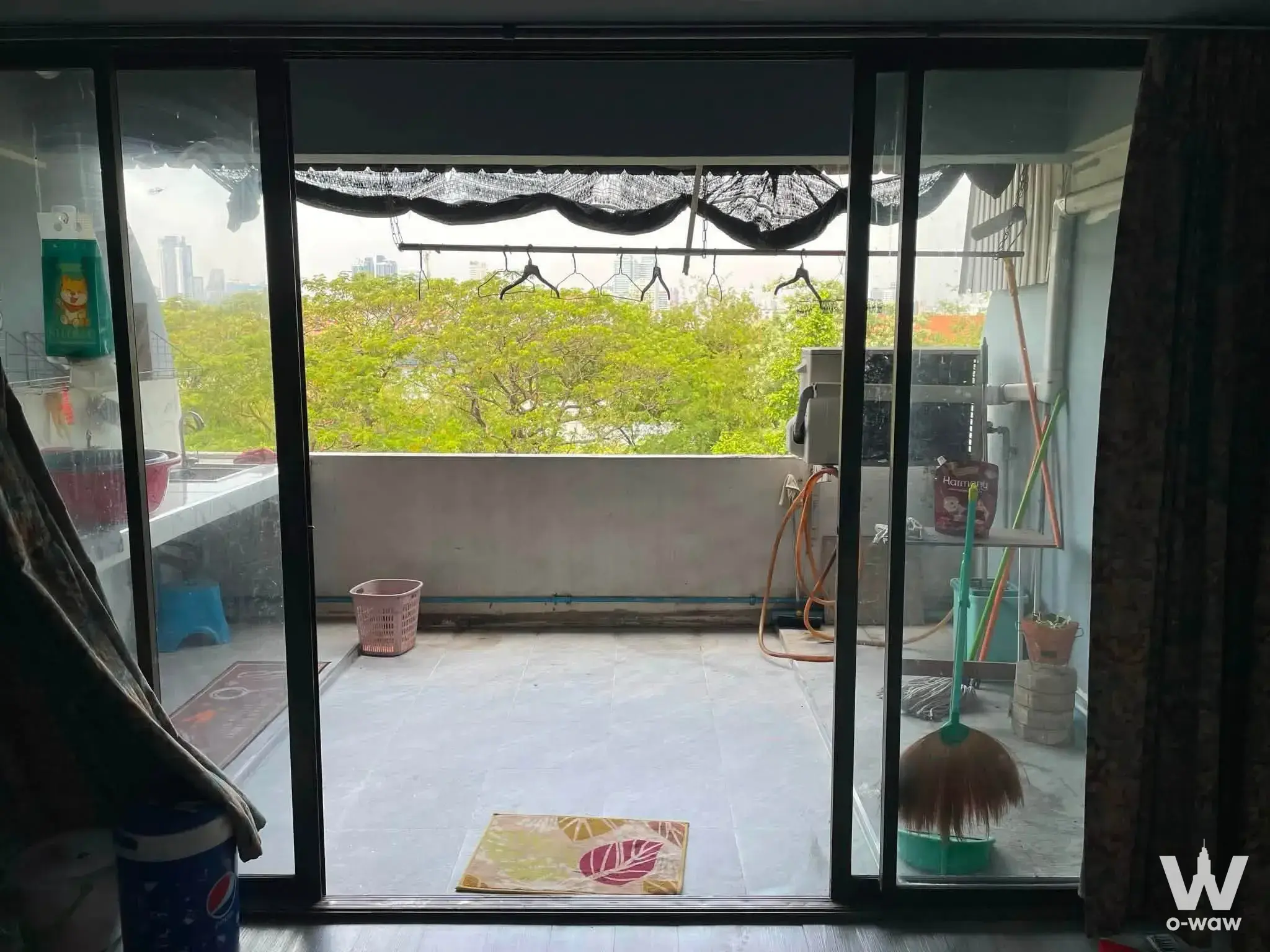 Balcony with glass sliding doors and washing machine in this 1-bed condo for sale in Ban Suan Ratchada