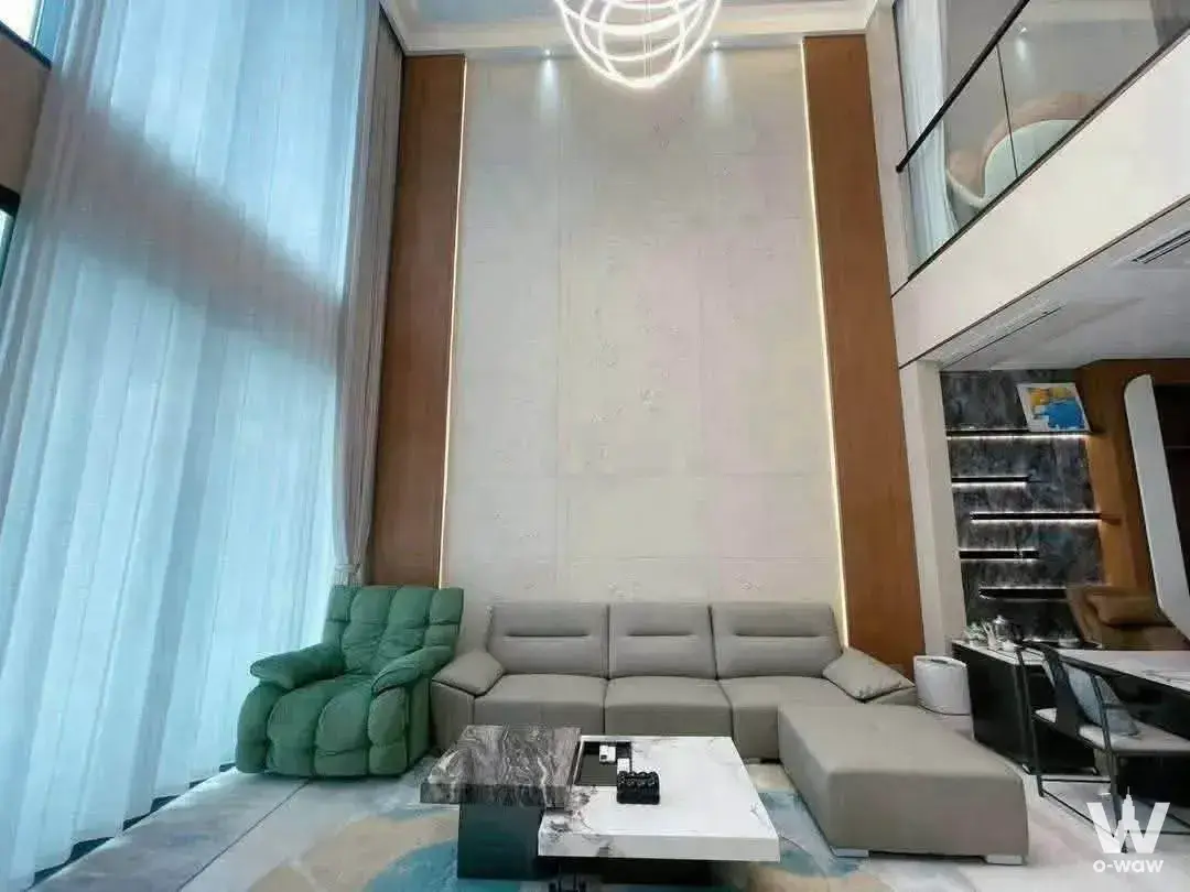 Double-height living room with wireframe chandelier and marble coffee table in a 4-bed Supalai Icon Sathorn condo