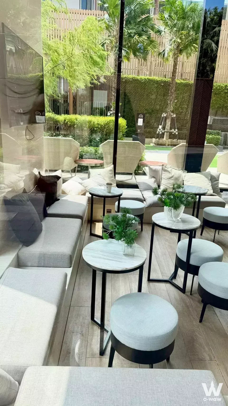MARU Ekkamai 2 lounge with grey sectional sofa overlooking garden