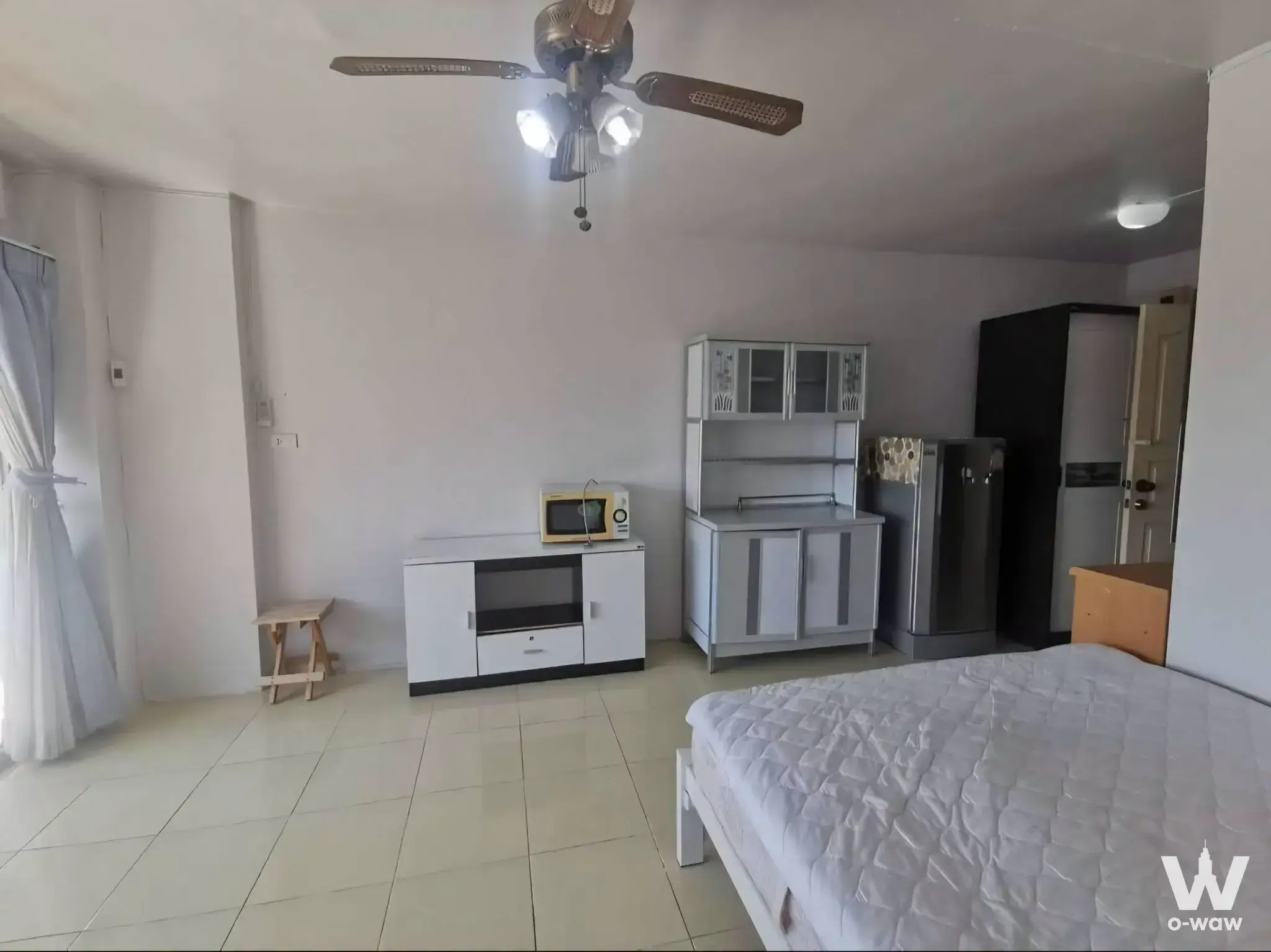 Basic studio apartment in Family Park Condominium with kitchenette and queen-size bed