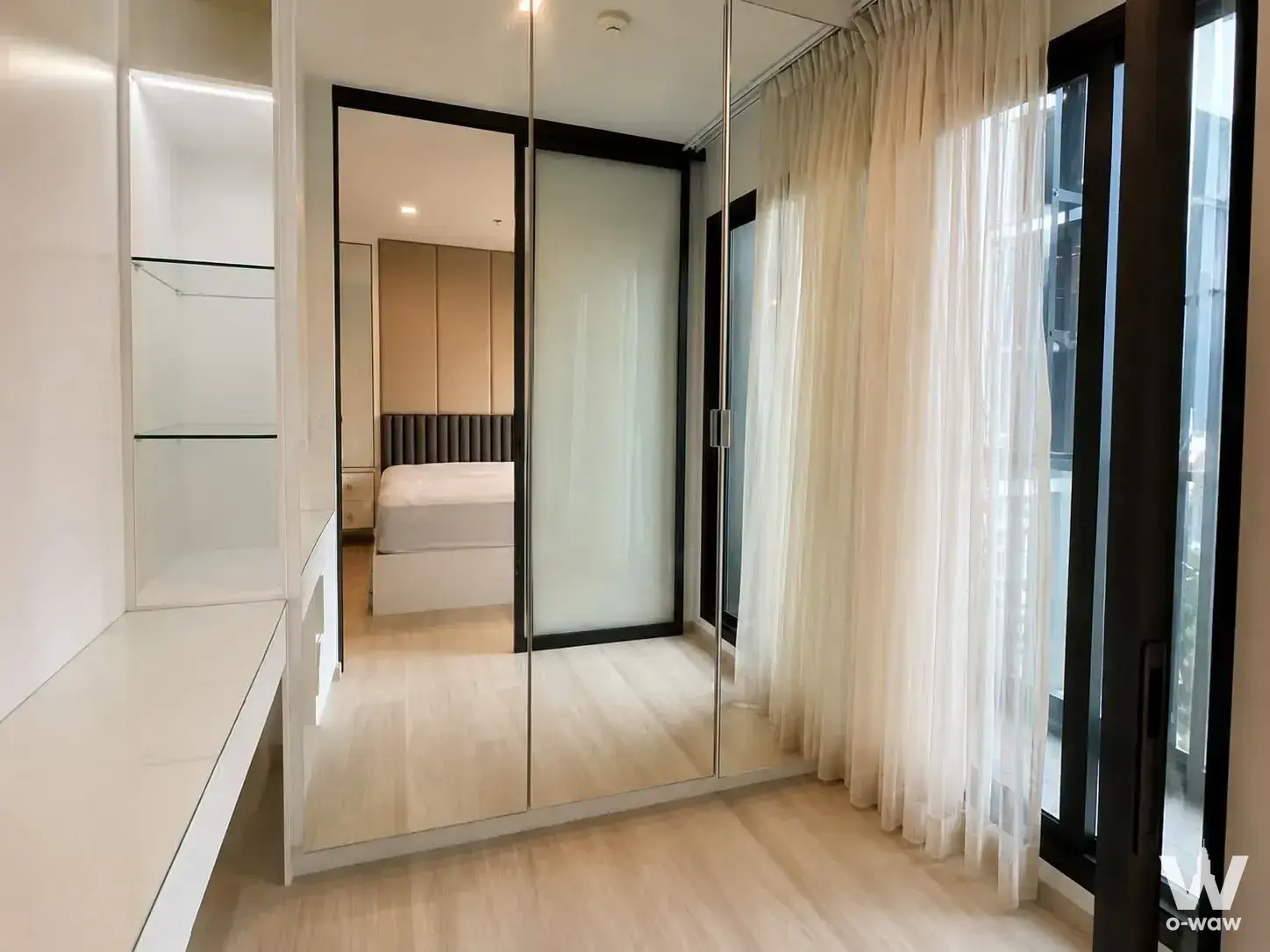1-bed condo for sale in Life One Wireless featuring LED-lit closet shelves and mirrored wardrobe