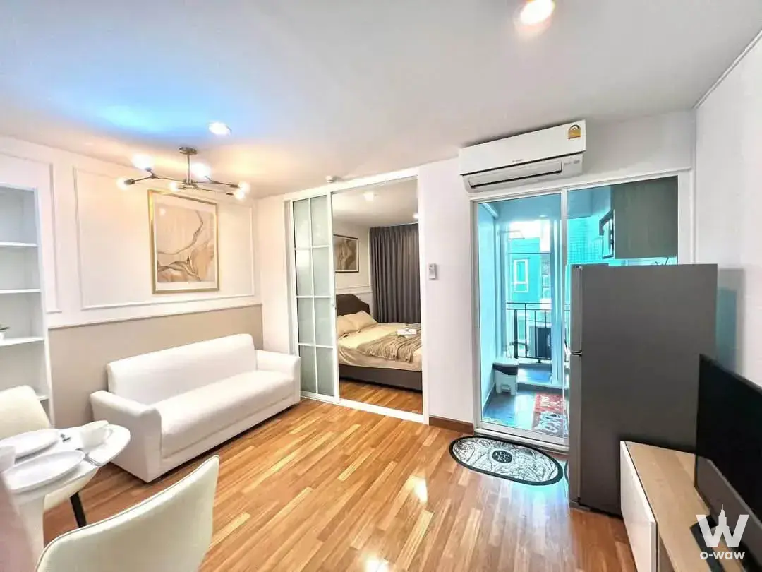 Furnished Regent Home 18 condo showing a sliding door to the balcony and modern living area