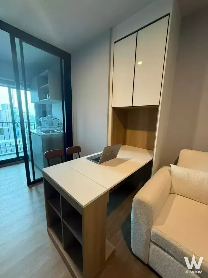Studio with built-in desk and balcony view in 1-bed condo for rent at Nue Evo Ari