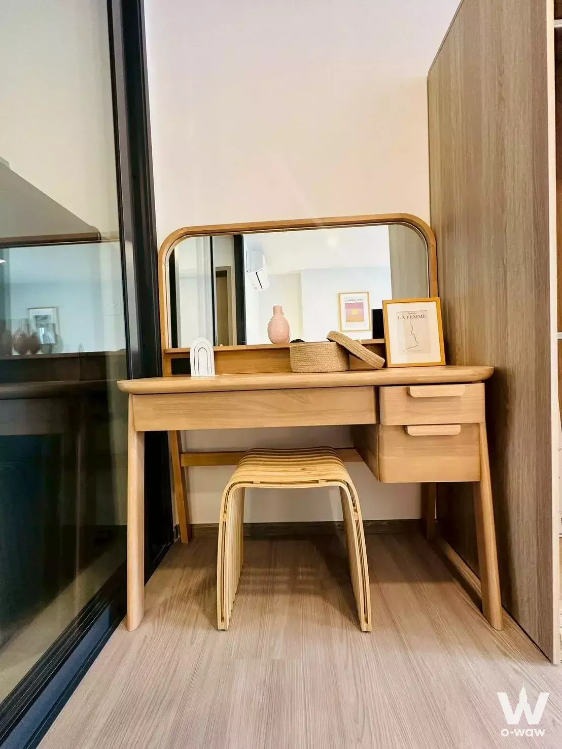 Mid-century modern vanity area with oak desk, mirror, and bentwood stool in Aspire Sukhumvit-Rama 4 condo