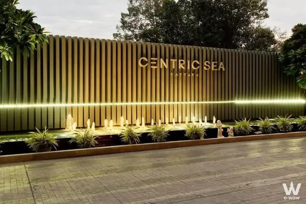 Centric Sea Pattaya entrance with gold signage, water feature, and stone Buddha statues