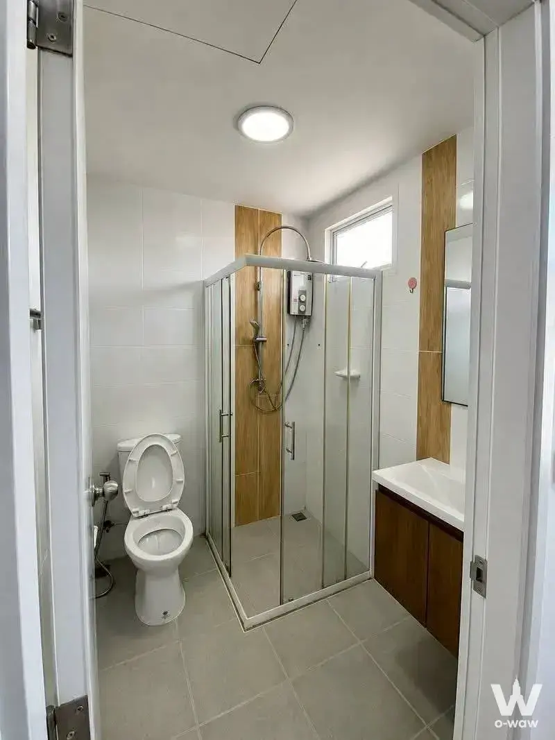 Modern bathroom in villette city pattanakarn 3-bed townhouse with corner shower, floating vanity, and wood accents