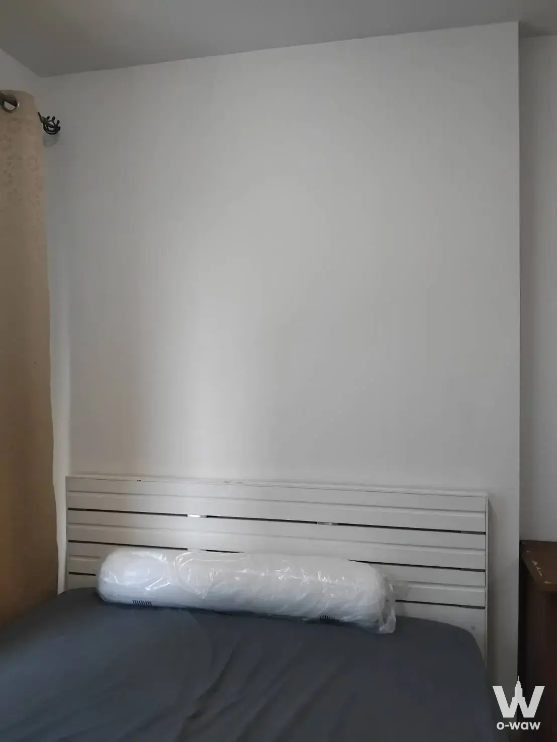 1-bed condo bedroom for sale in Plum Condo Bangkae with white slat headboard and neutral decor