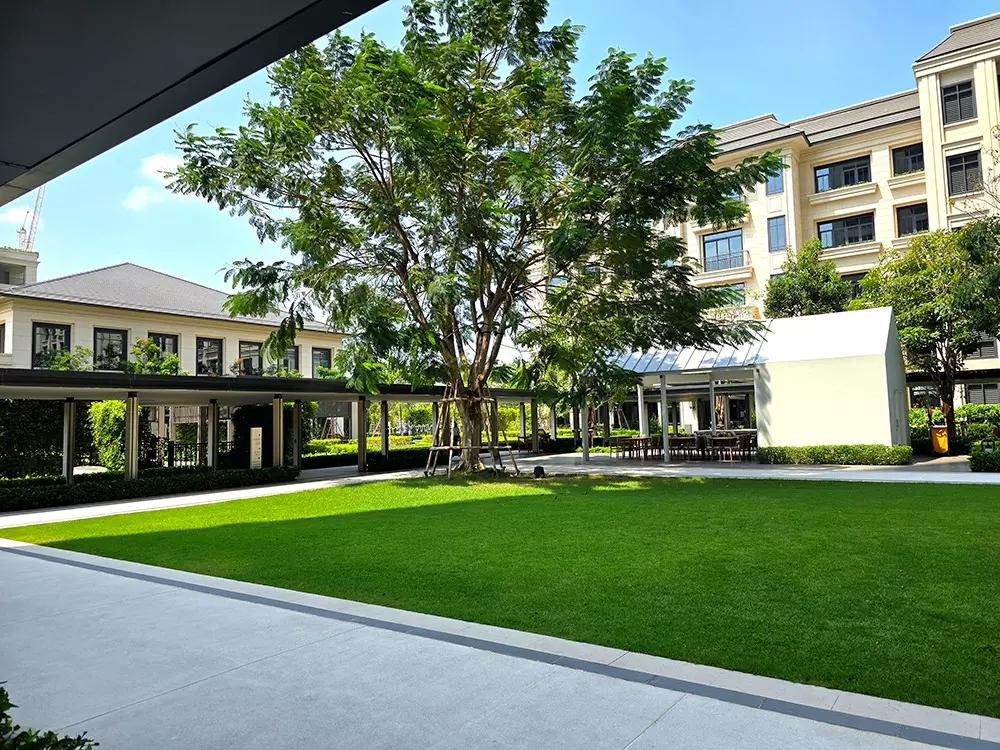 Manicured lawn and shaded pavilion in the communal courtyard of The Aspen Tree Residences at The Forestias