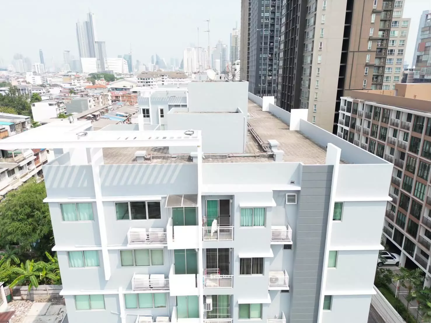 High-angle view of residential building balconies and urban skyline near My Condo Sathon-Taksin for sale