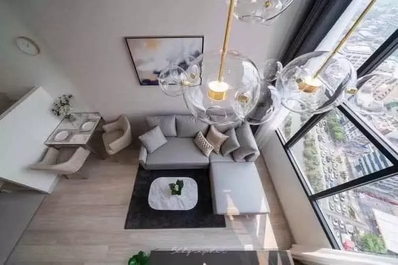 Living room in 1-bed condo for rent at KnightsBridge Prime Sathon with sectional sofa and city view