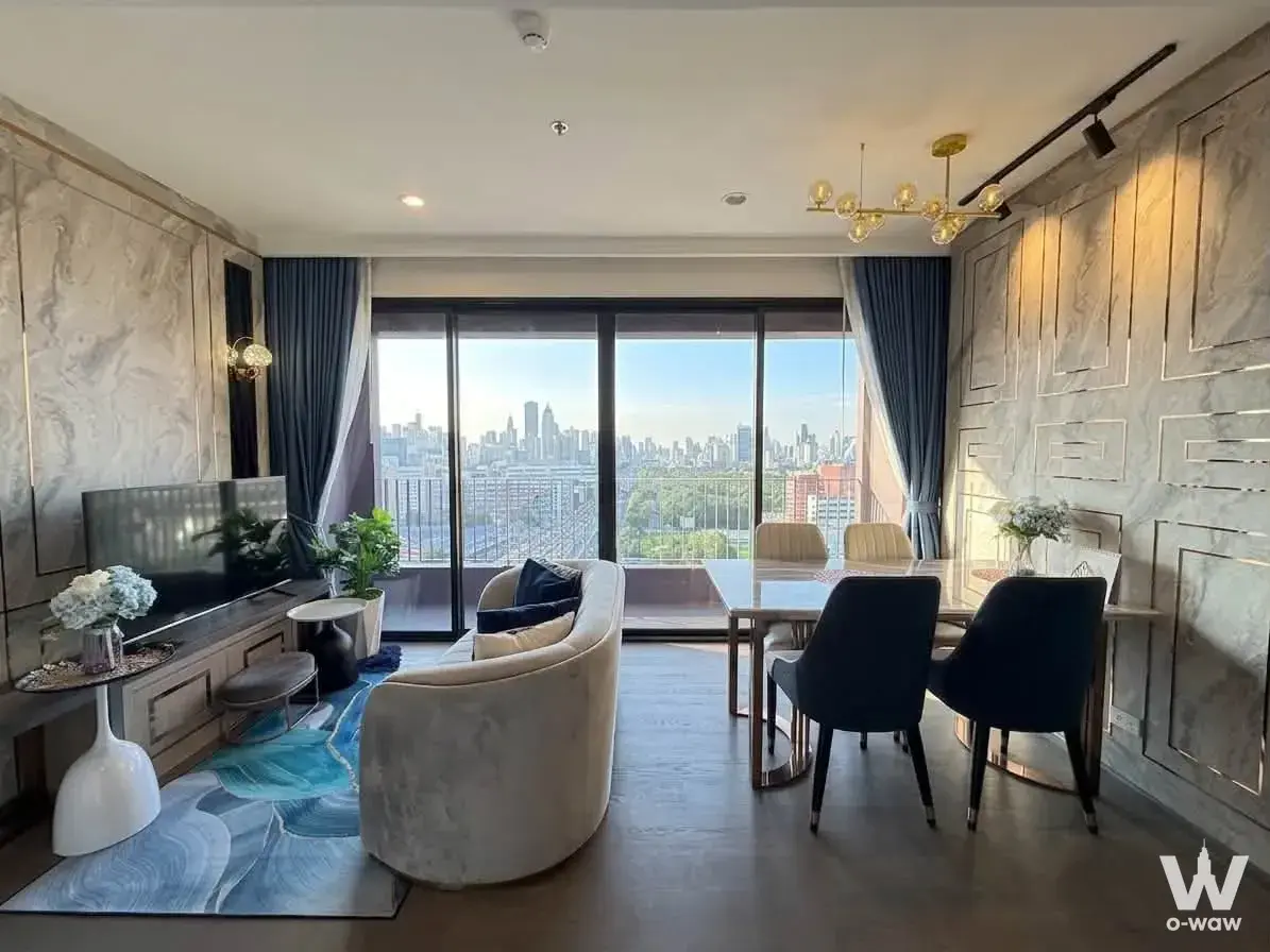 Cream velvet sofa and marble dining table in this 2-bed Coco Parc condo for rent with city skyline views