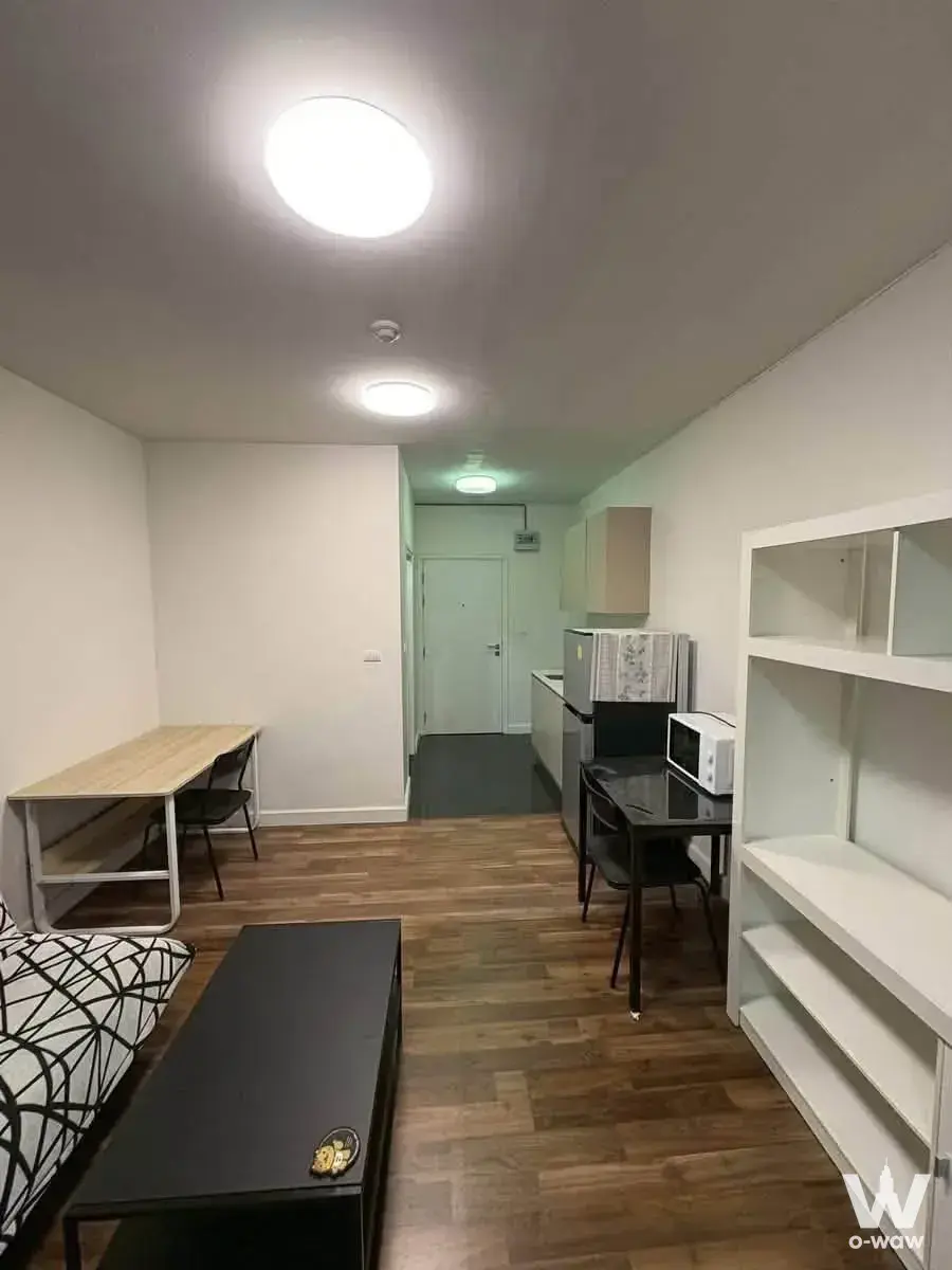 Functional studio apartment with open plan layout, shelving, and kitchenette in an A Space ME Sukhumvit 77 1-bed condo