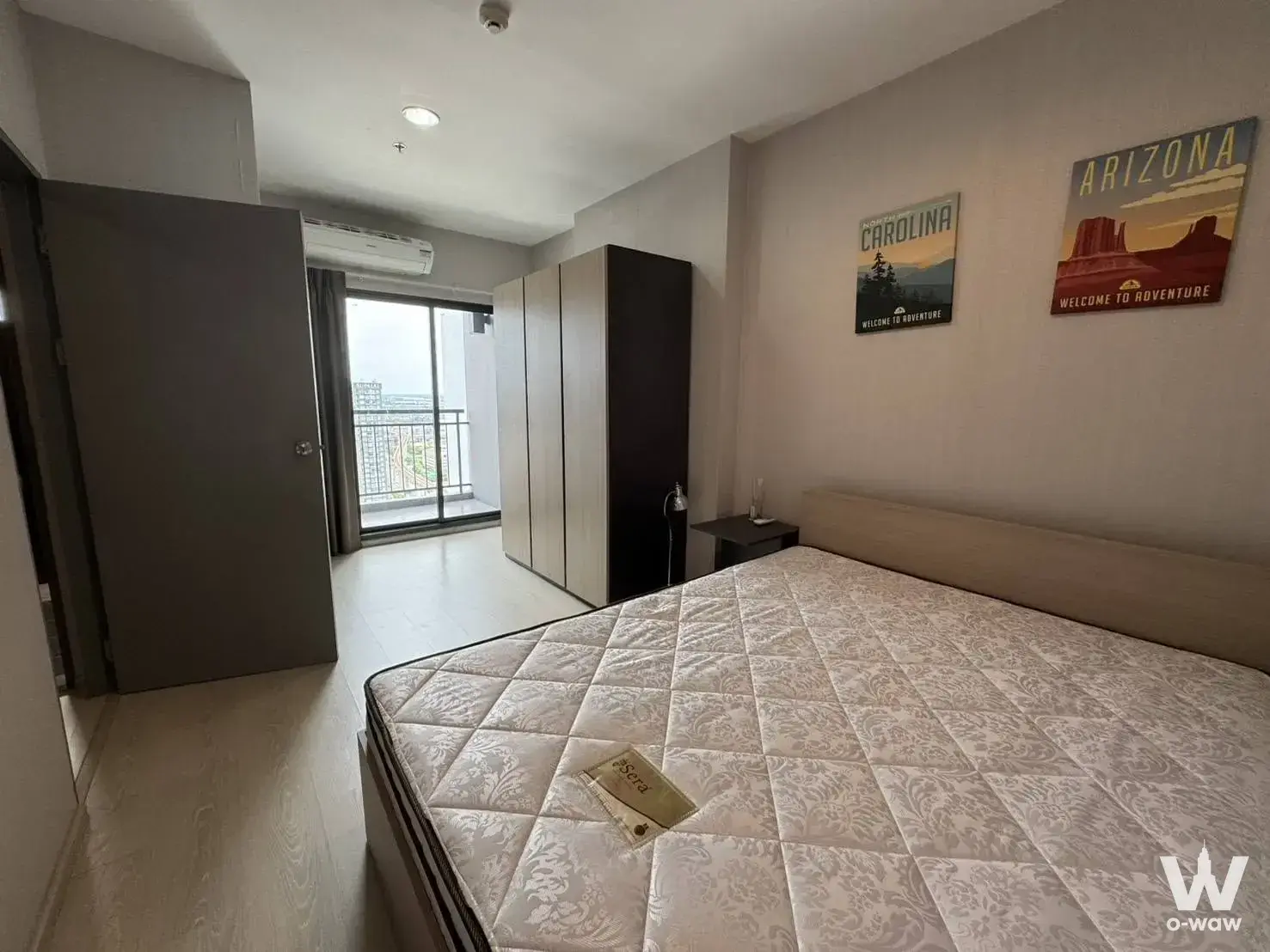 Modern bedroom in IDEO Sukhumvit 115 with a queen bed and large wardrobe overlooking the city
