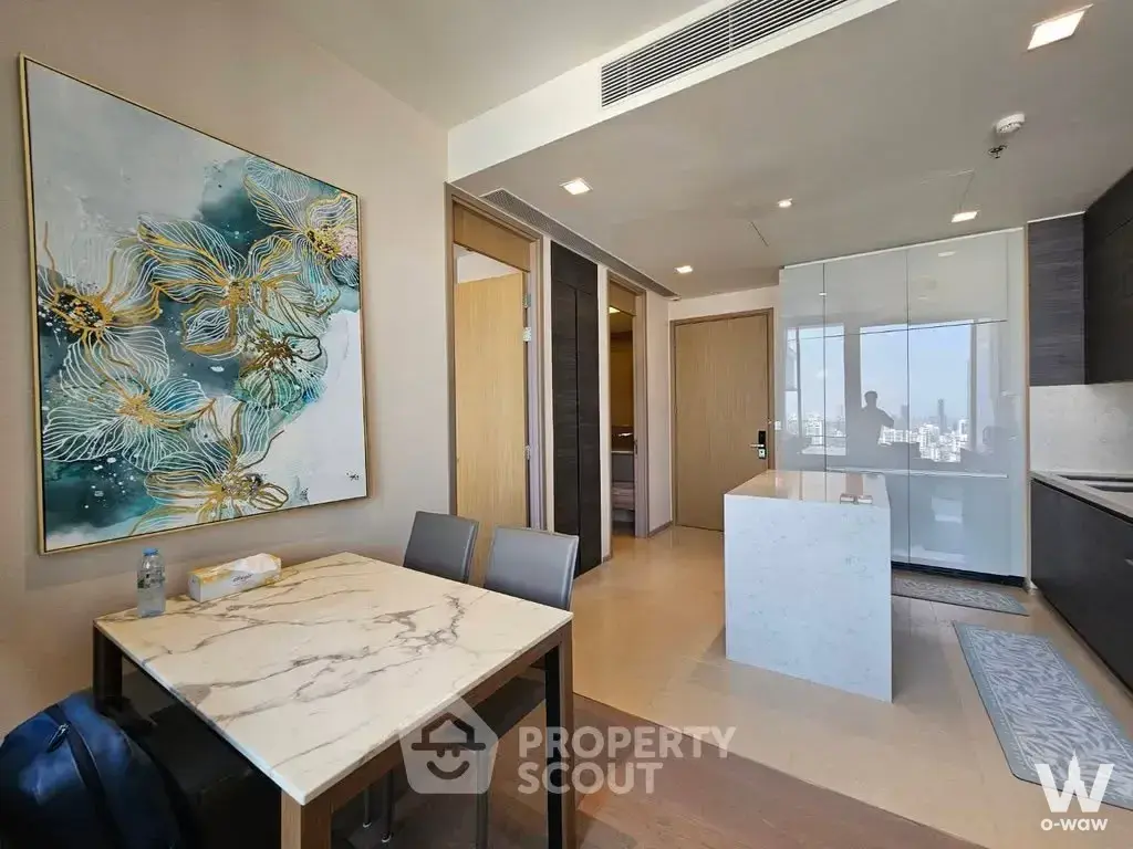 Dining area in THE ESSE ASOKE condo with marble table, dark cabinetry, and city view