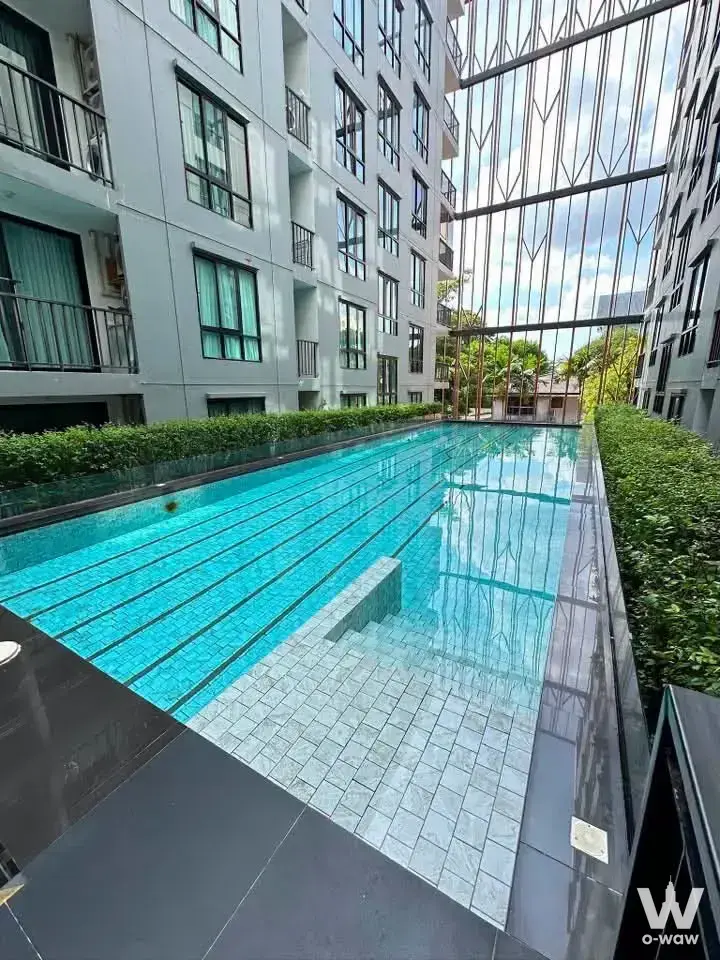 Lap pool with turquoise tiles and steel canopy at Notting Hill The Exclusive Charoen Krung 93