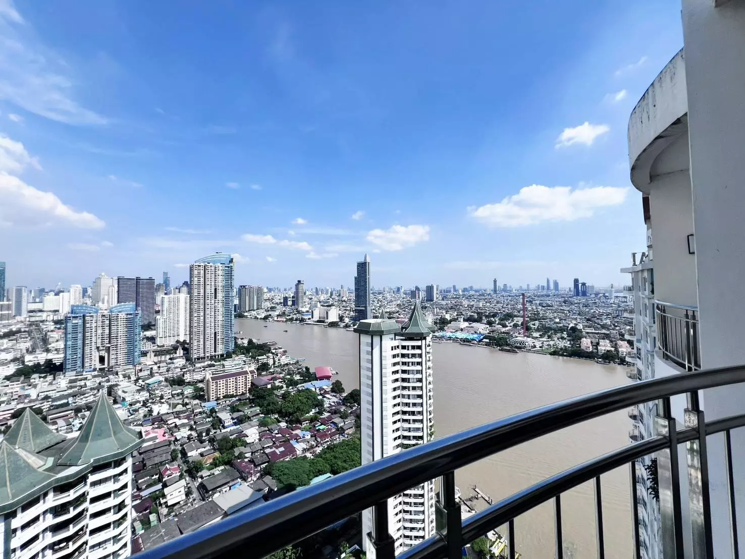High-floor balcony view from Supalai River Resort condo overlooking the river and city skyline