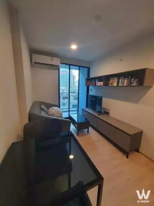 Modern living room in Premio Quinto condo with grey sofa and balcony city view
