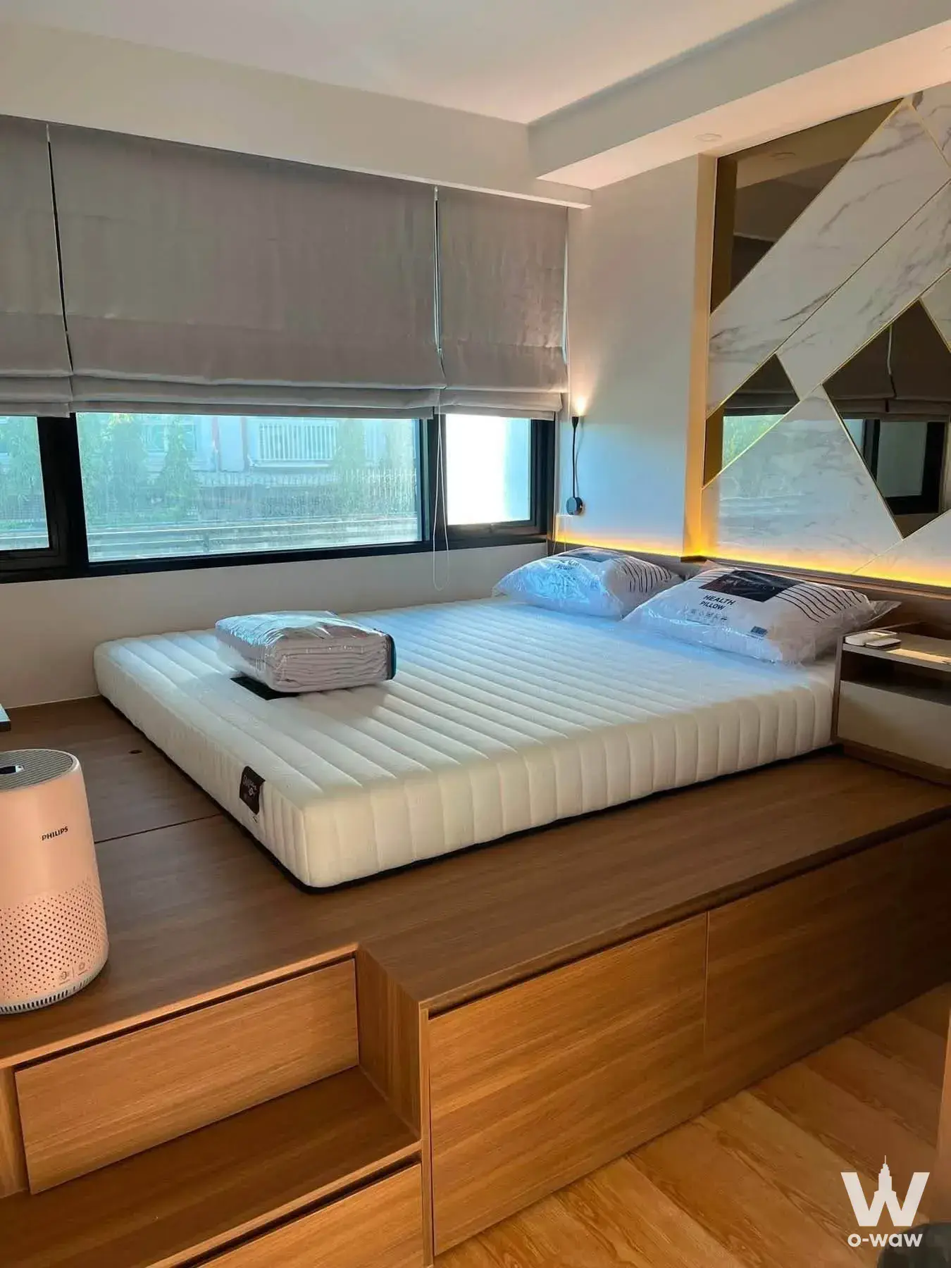 JRY Rama 9 bedroom with built-in platform bed and geometric gold-trimmed headboard wall