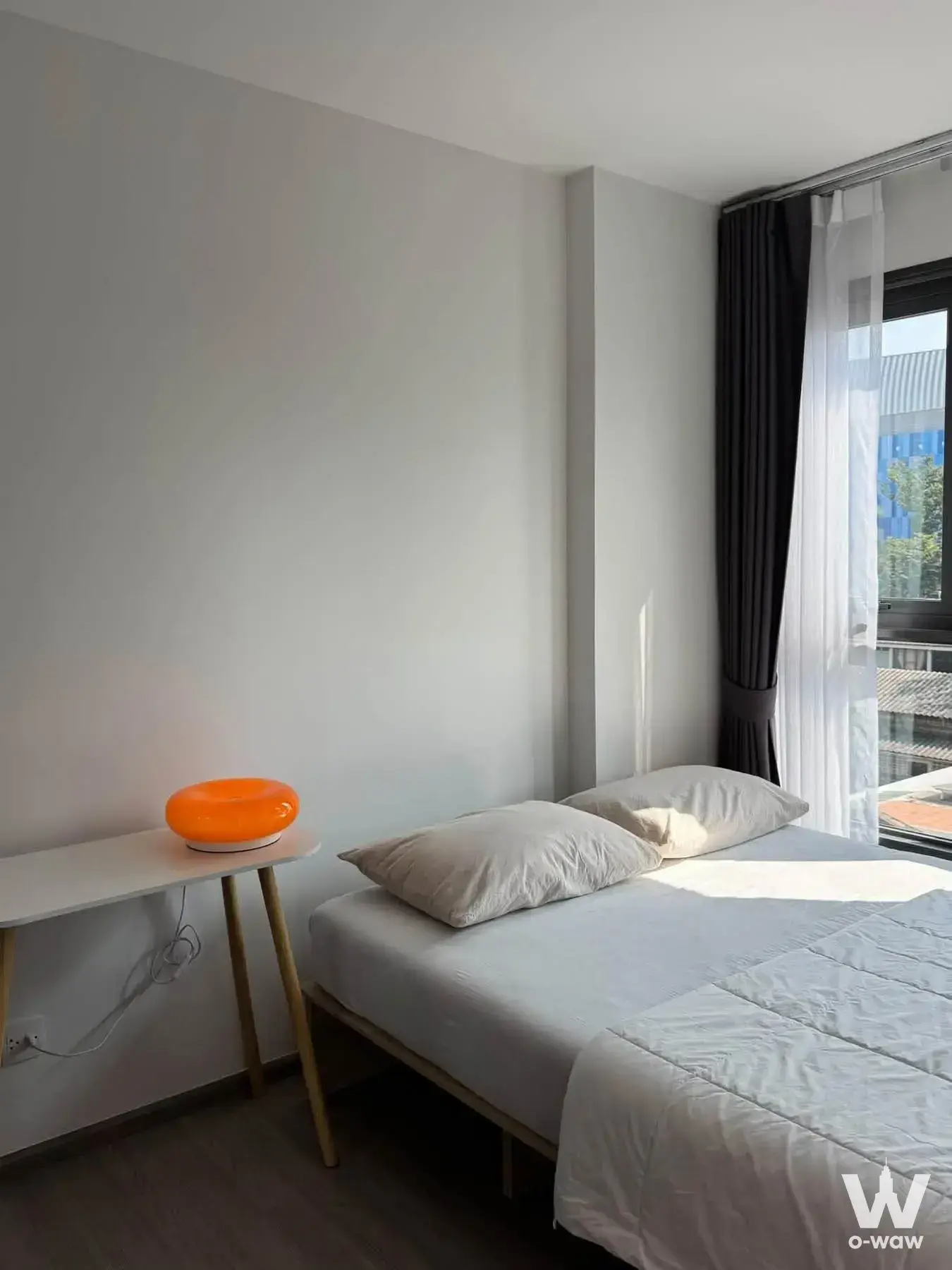 1-bed other for rent in Aspire Ratchayothin with minimalist bedroom and bright orange lamp accent