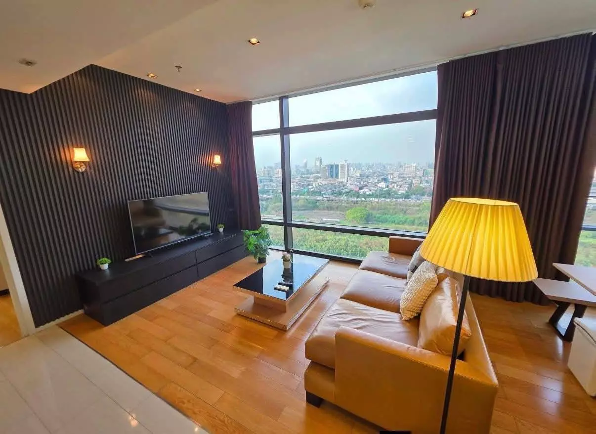 Modern living room with charcoal fluted accent wall and city views in Circle Living Prototype condo