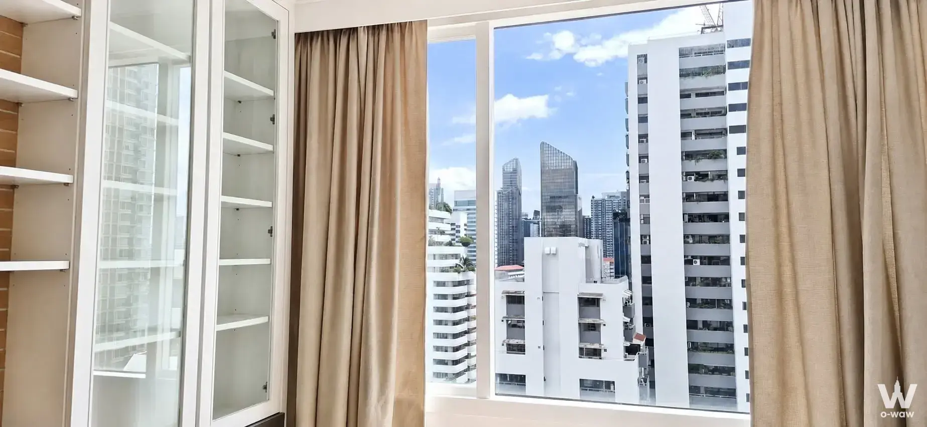 Bedroom window offering city views from this 1-bed condo for sale at Wind Sukhumvit 23