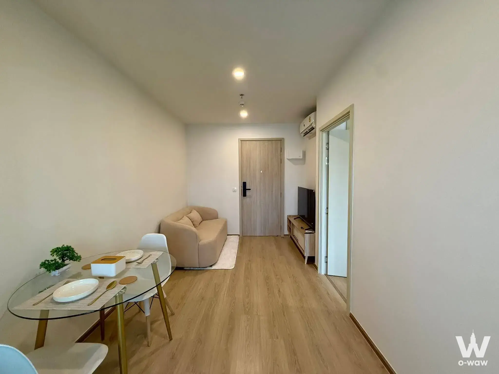 Compact living area with dining table and sofa in Life Rama 4 - Asoke condo