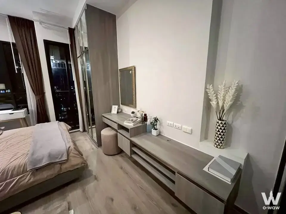 KnightsBridge Prime Onnut 1-bed bedroom with night city skyline view and grey wood-grain built-in furniture