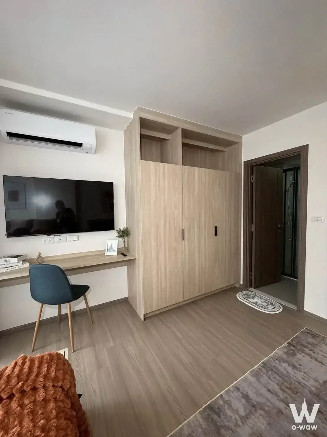 Furnished bedroom with floating desk and wardrobe in The Muve Pradipat condo