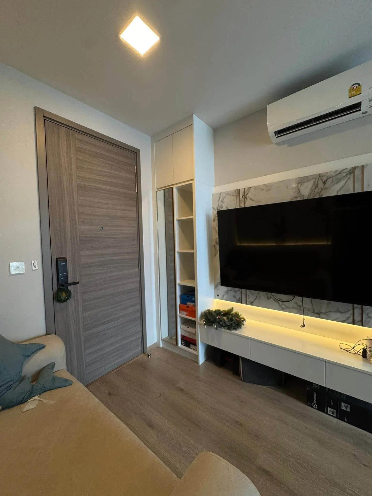 The Privacy Taopoon Interchange living room with grey sofa, marble TV wall, and smart lock