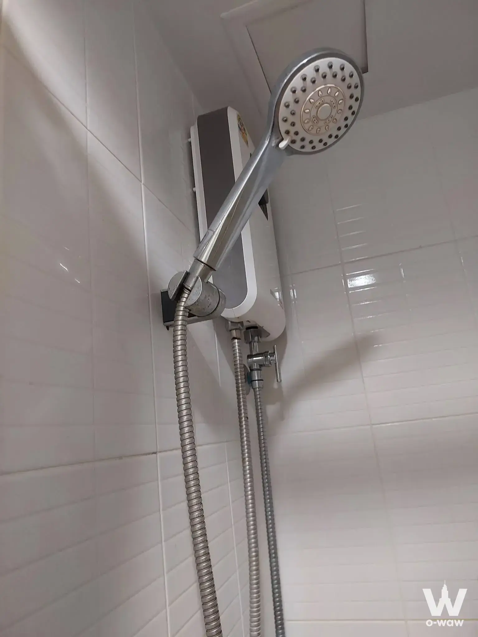 Lumpini Condo Town Nida SeriThai bathroom with white tiles and wall-mounted shower