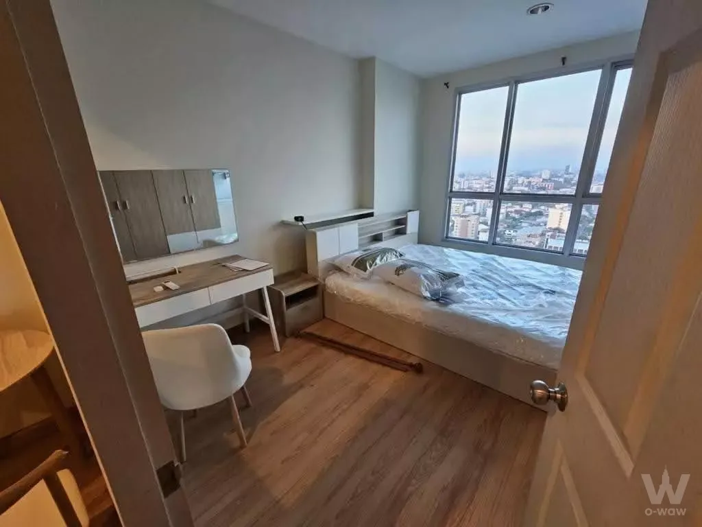 Modern bedroom in Life @ Ratchada-Suthisan with city view, built-in storage headboard, and vanity desk