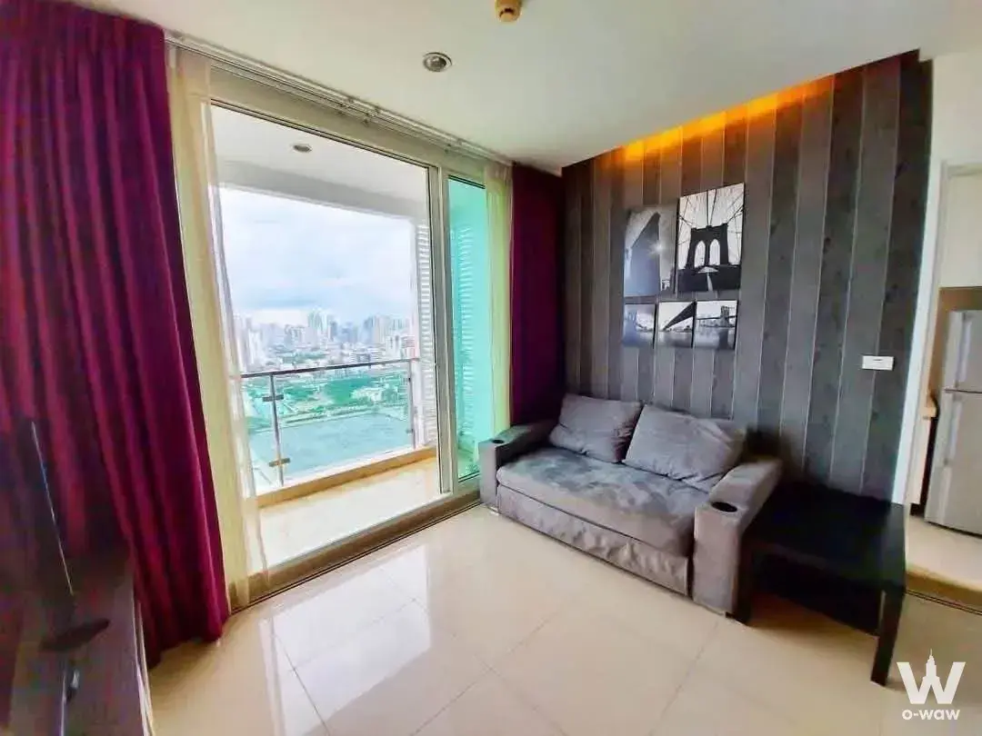 Living room with grey wood accent wall, magenta curtains, and balcony overlooking urban skyline