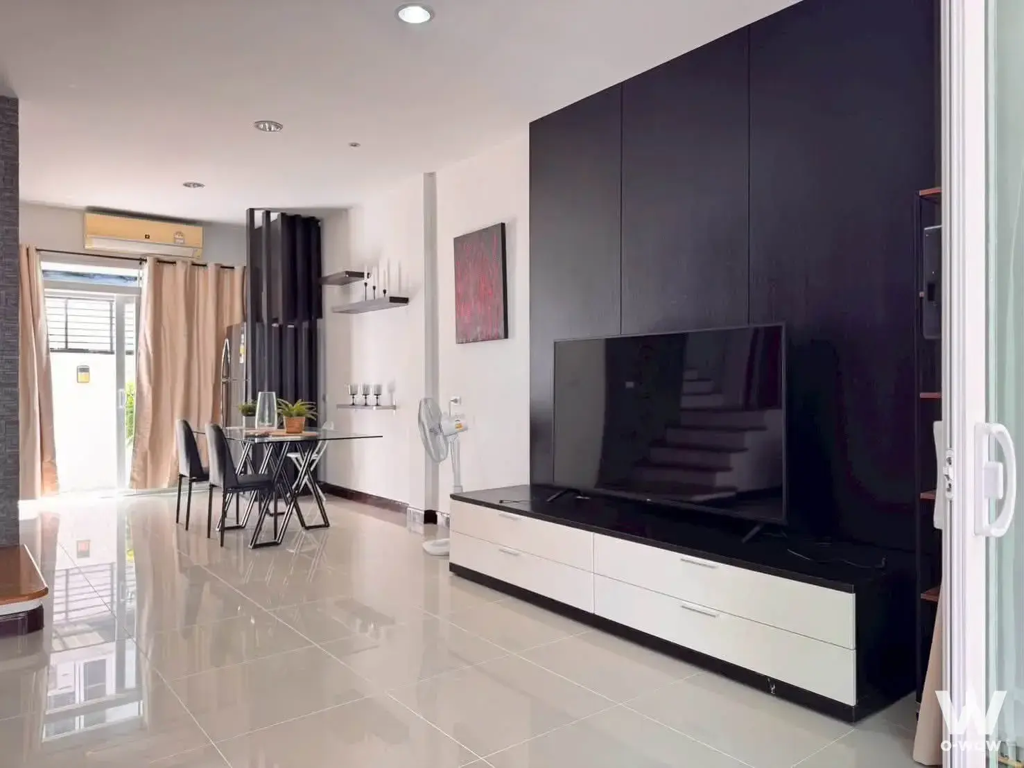 Spacious 2-bed townhouse for rent in Baan Klang Muang Urbanion Rama 9-Ladprao with dark wood feature wall and balcony view