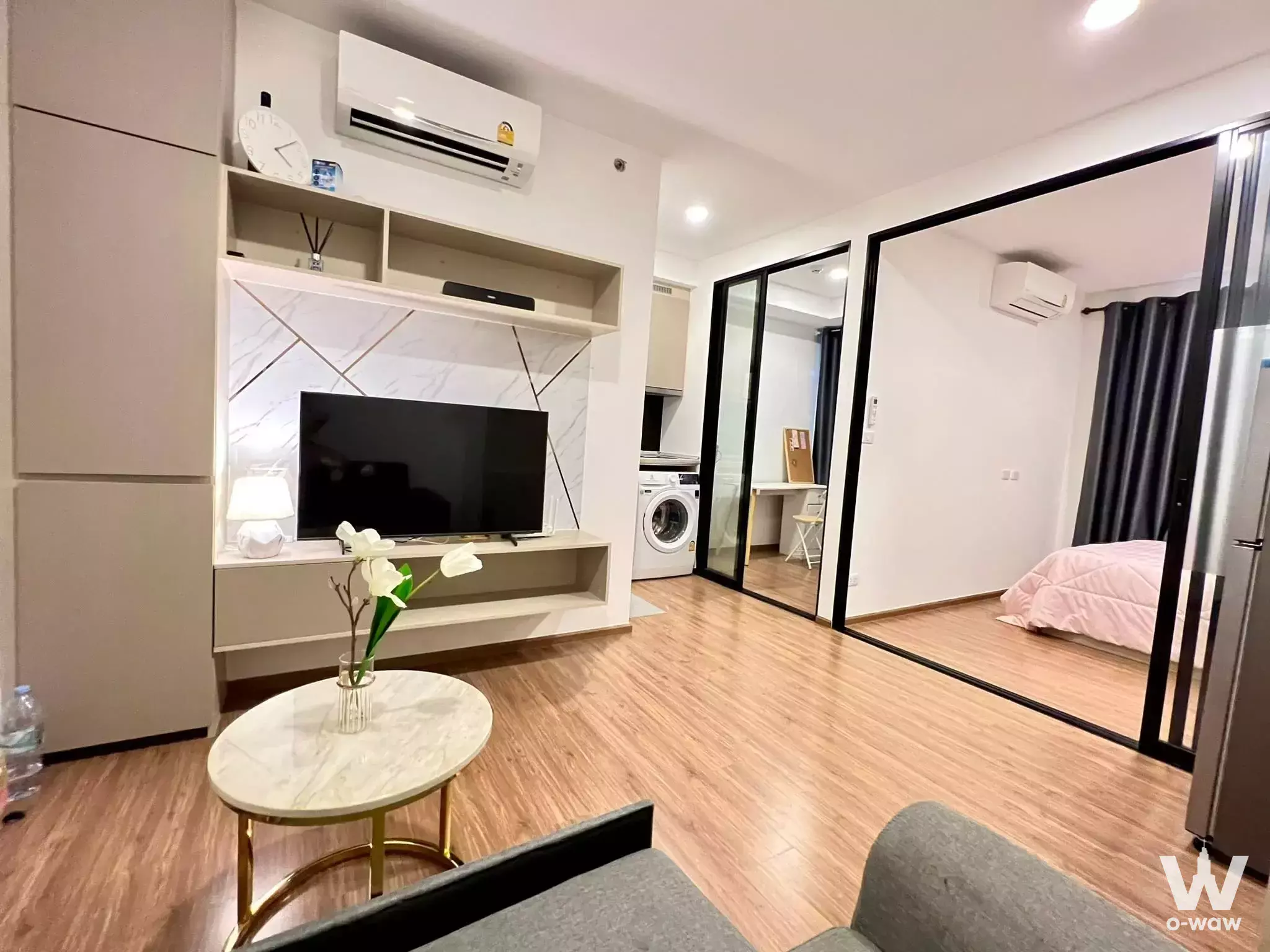 Open-plan studio in The Origin Ram 209 Interchange featuring marble coffee table and built-in TV unit