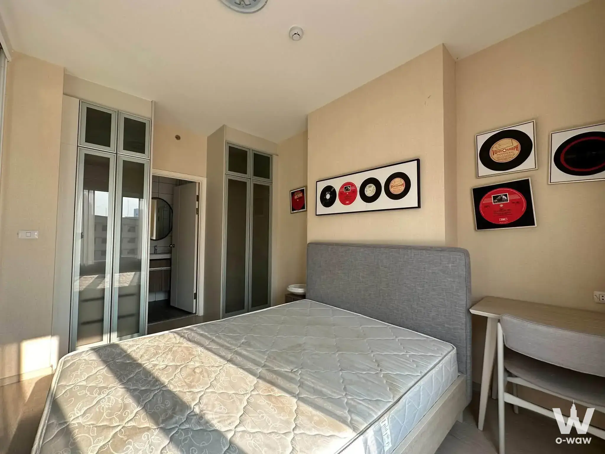 Sunlit bedroom with queen bed and desk in Chapter One Eco Ratchada-HuaiKhwang rental