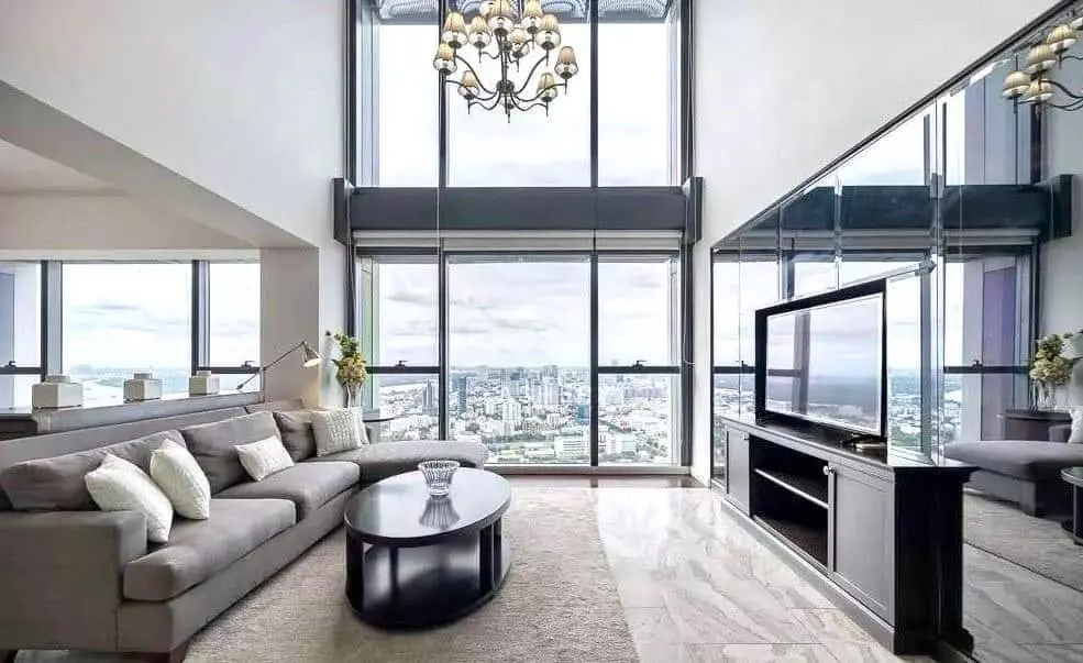 Spacious living room in 4-bed Met Condominium rental with panoramic city views and marble floors