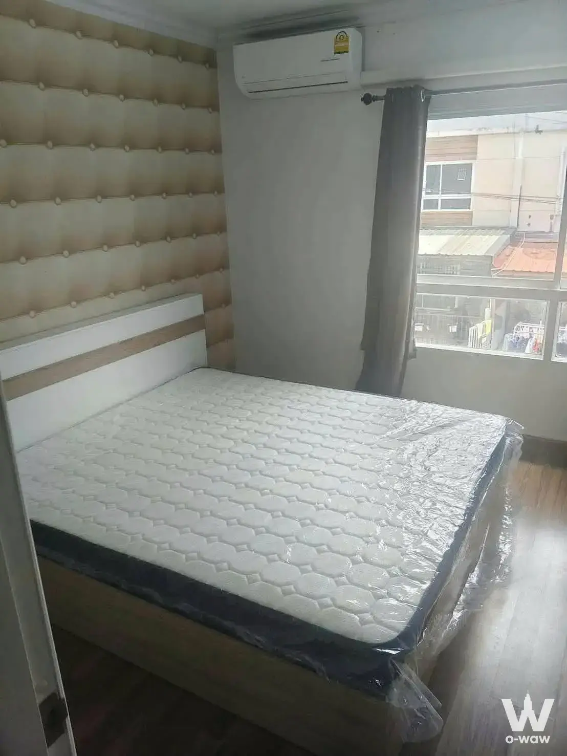 Bedroom in a 3-bed townhouse for rent at Villette Lite with a queen bed, tall tufted wall panel and city view