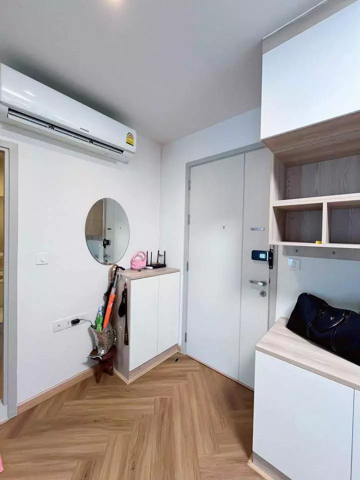 Life Sukhumvit 48 entryway with herringbone floors, smart lock door, and white built-in storage