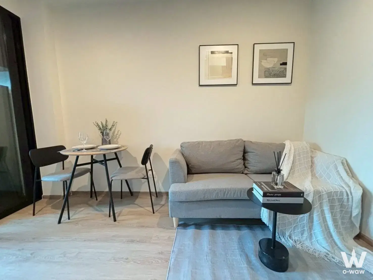 Modern 1-bed condo living room in Nue District R9 with grey sofa and minimalist dining area