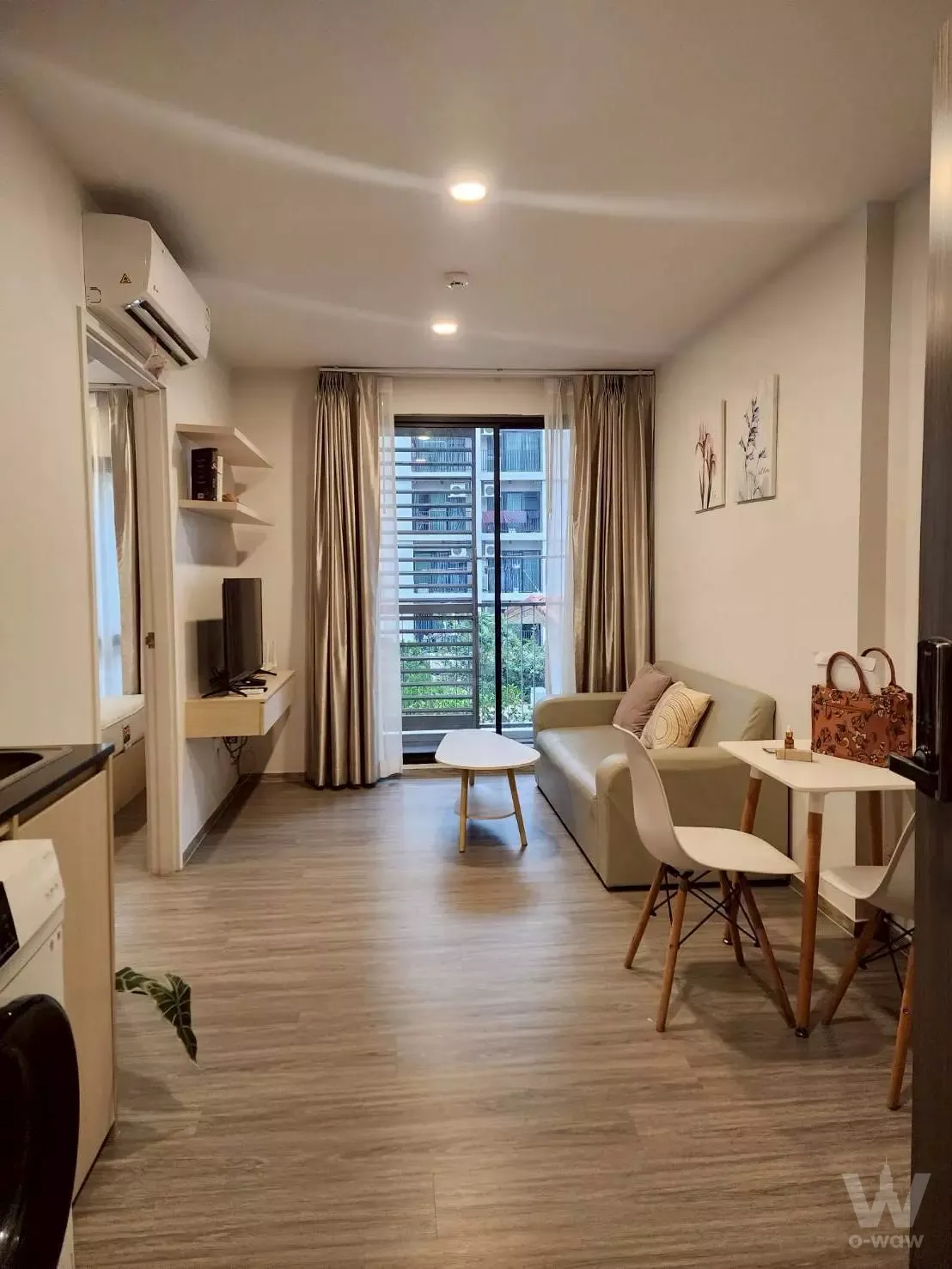 Sage green sofa and dining set in DOLCE LA SALLE 1-bed condo for sale with balcony access