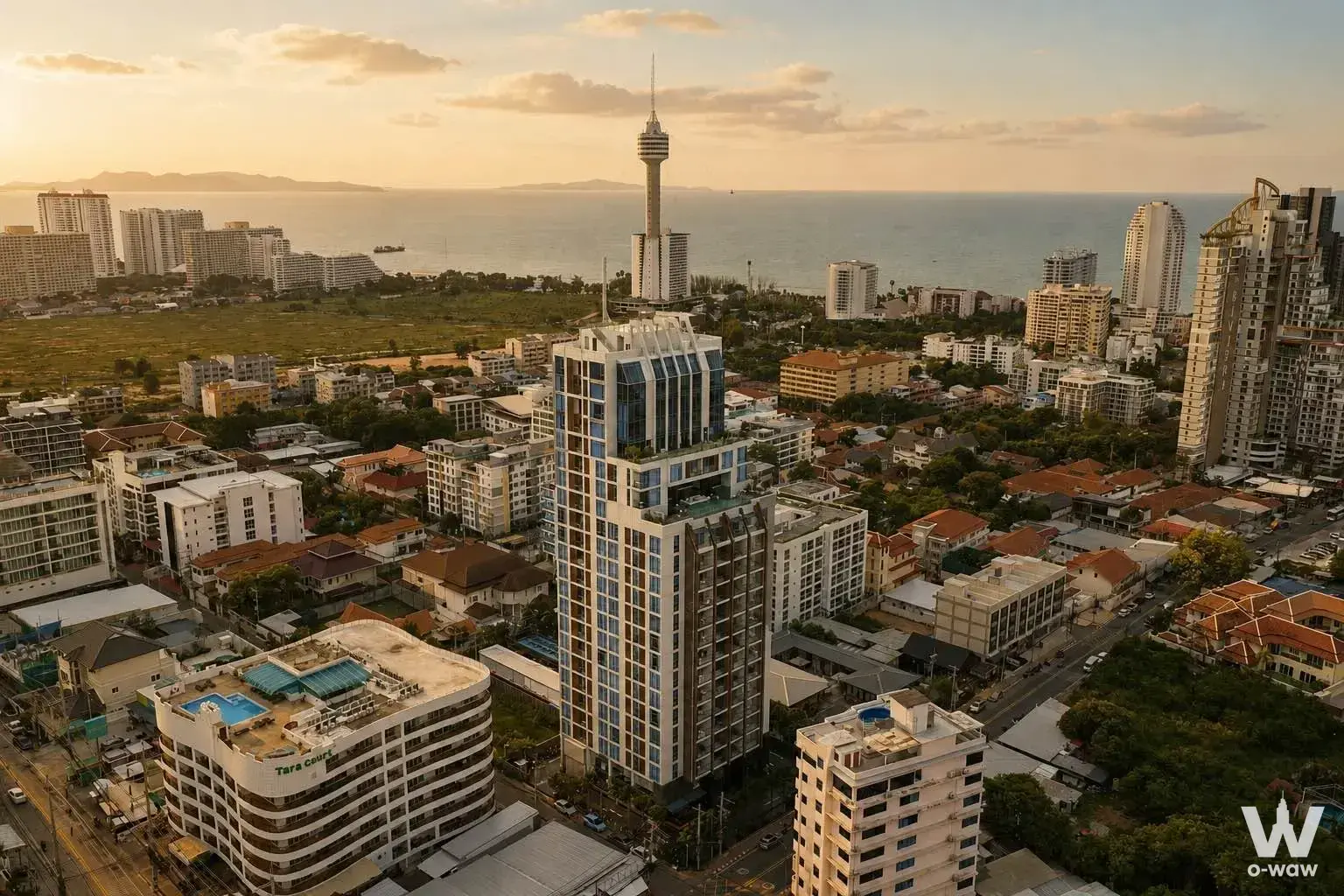 Beverly Mountain Bay Pattaya high-rise tower aerial view with pool deck and ocean horizon