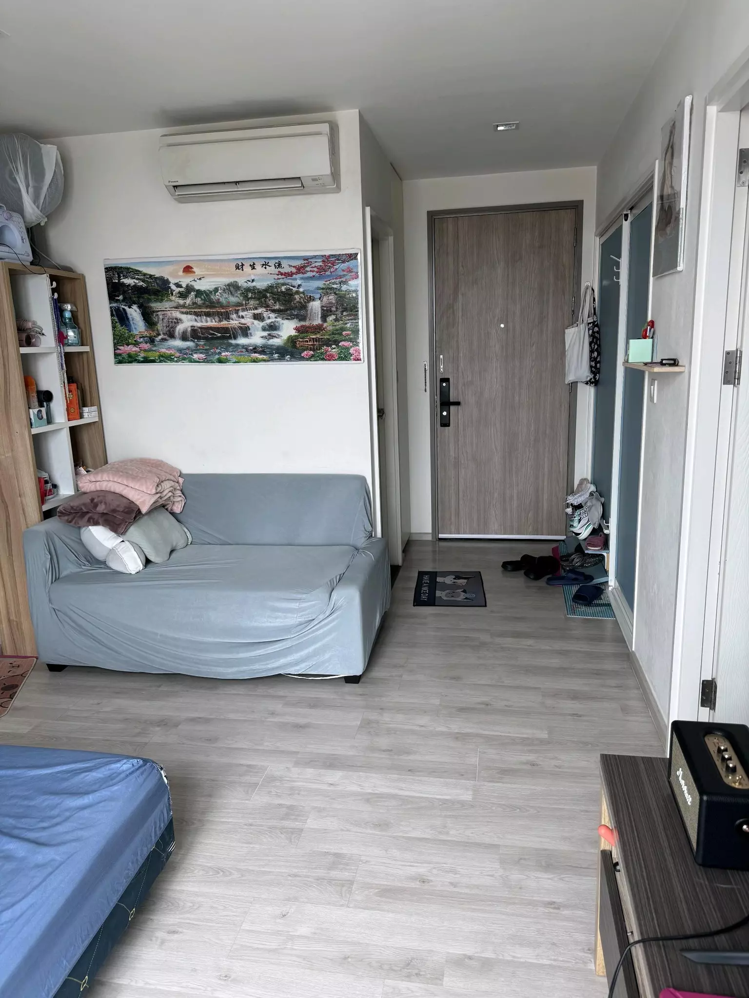 Multi-functional room in 2-bed condo for sale at Chambers Chaan with sofa bed, blue mattress, and shelving