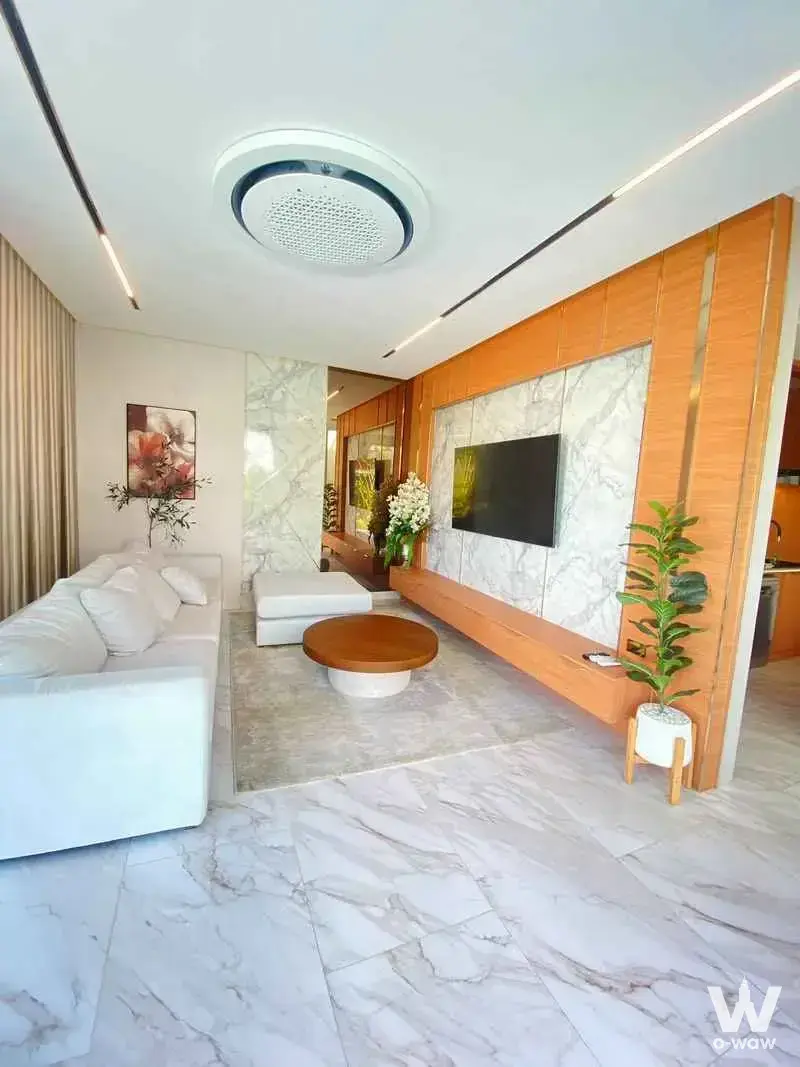 Luxury living room in a 5-bed house for sale at Atmos Prime Villa Pattaya featuring white leather sofa and marble floor