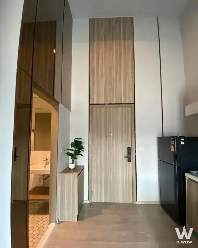 Modern entryway at Altitude Unicorn-Tha Phra with floor-to-ceiling wood cabinetry, smart lock, and bathroom view
