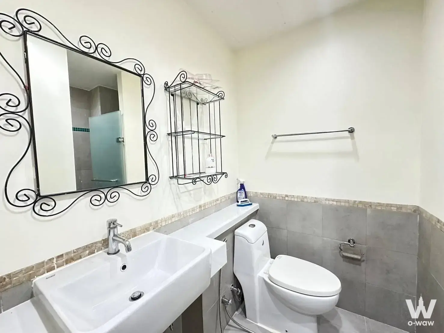 Bathroom with grey tile wainscoting and vessel sink in 2-bed condo for rent at The Muse Sukhumvit