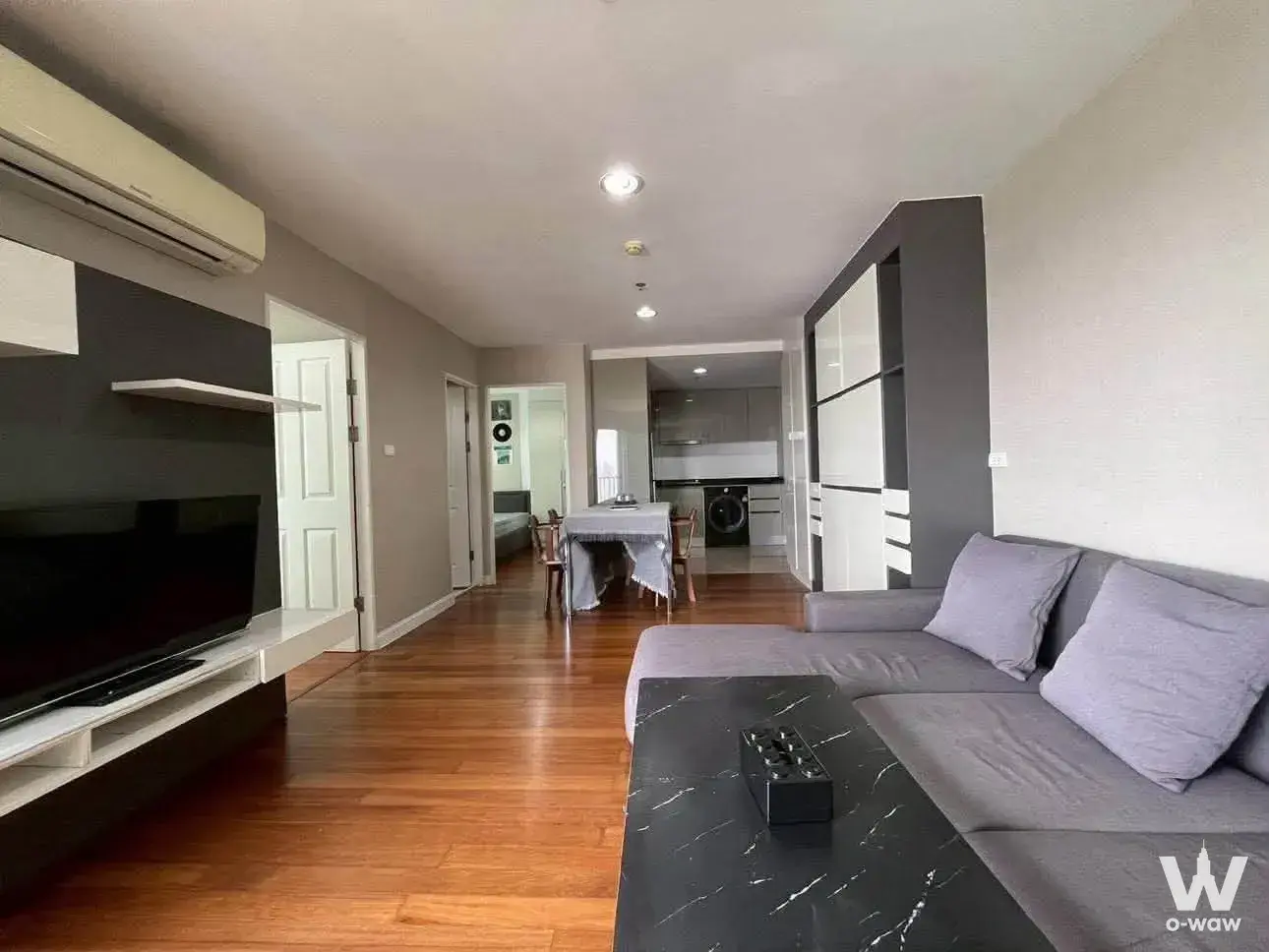 2-bed condo for rent in Belle Grand Rama 9 with a furnished living room, media unit, and open-plan layout
