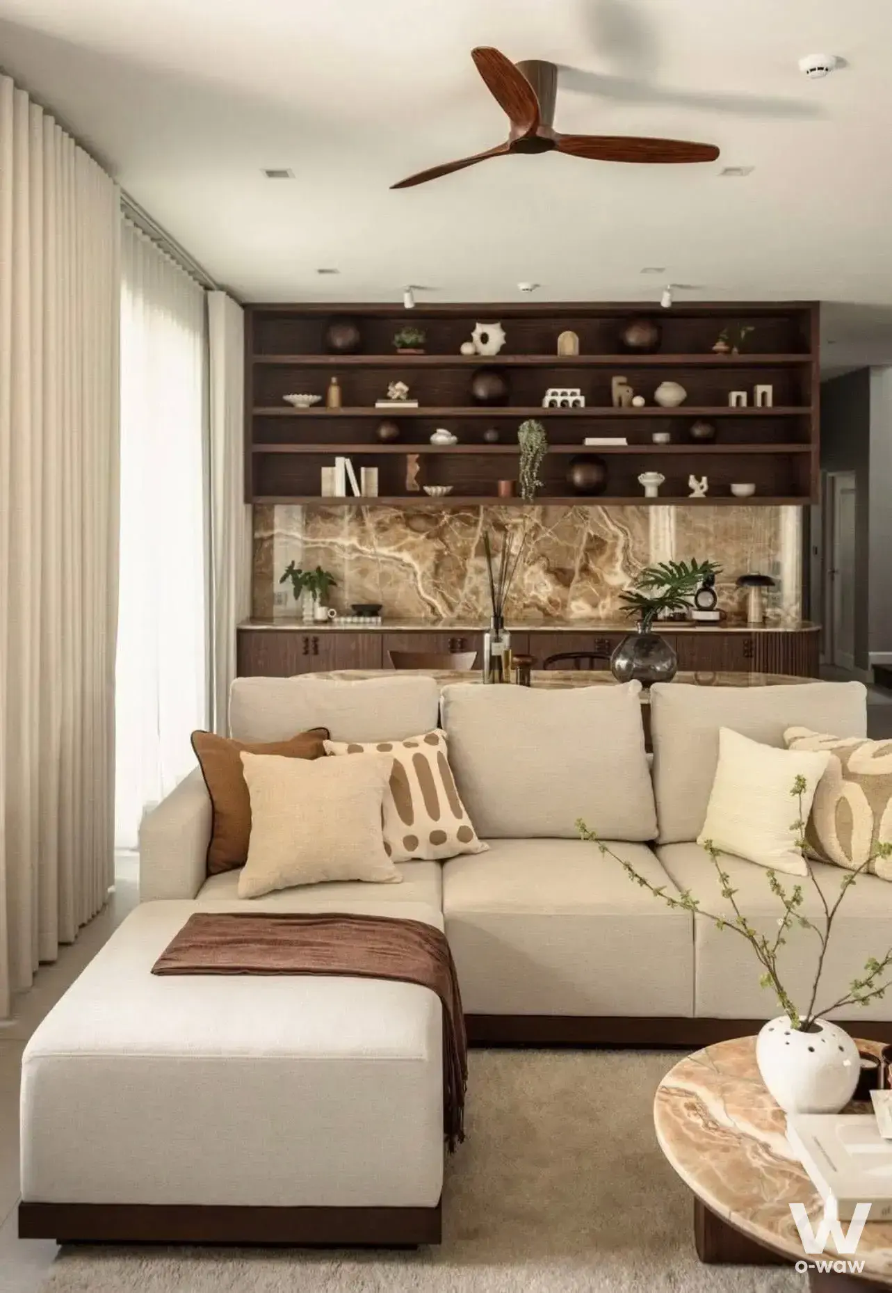 Modern living room in Grand Bangkok Boulevard Sathorn condo with beige sofa and marble coffee table