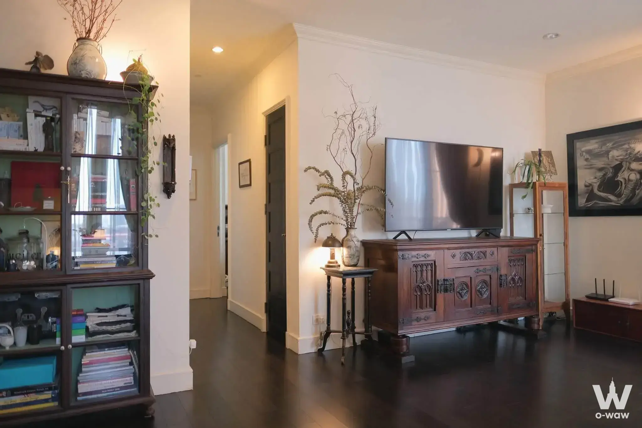 Aguston Sukhumvit 2-bed condo living room featuring traditional dark wood furniture and classic decor